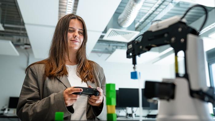 251125 A young woman operates a robot arm at Harper Adams420691 (1)
