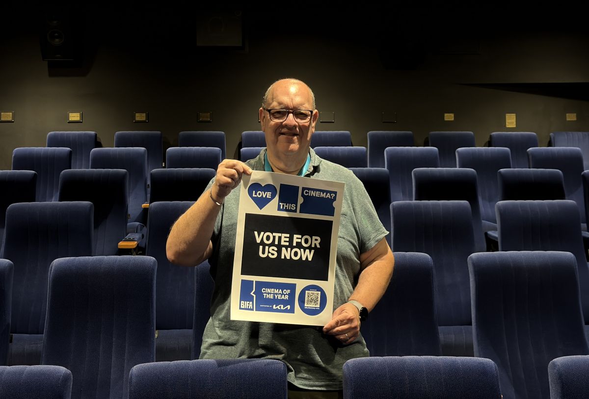 Graham Coty with a poster calling for local votes